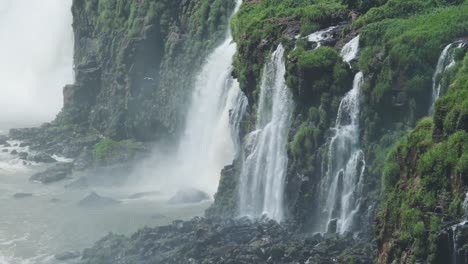 Iguazu-Falls-Waterfall-in-Brazil,-Dramatic-Rough-Waterfall-in-Green-Rainforest-Landscape,-Waterfalls-Crashing-and-splashing-onto-Large-Rocks-in-Iguacu-Falls,-South-America