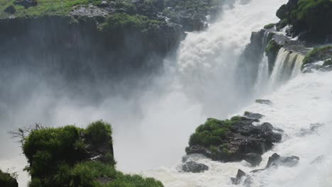 Huge-Cliff-Edge-With-Thick-Waterfalls-Pouring-off-Steep-River-into-Splashing-Water-Abyss,-Flying-Water-Splash-From-Rough-Aggressive-Slow-Motion-Waterfalls-in-Iguazu-Falls,-Argentina,-South-America