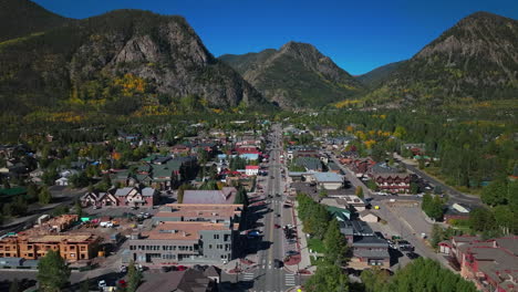 Traffic-main-street-Downtown-Frisco-Colorado-aerial-cinematic-drone-early-yellow-fall-colors-Aspen-trees-morning-Lake-Dillon-Keystone-Breckenridge-Silverthorne-Ten-Mile-Range-blue-sky-forward-motion