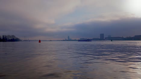 Foggy-Environment-over-the-North-Sea-Canal-with-a-Tanker-Ship-passing-by,-Amsterdam-City