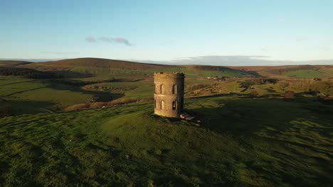 Historic-stone-tower-on-grassy-hill