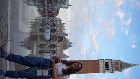 Young-traveler-woman-admires-architecture-of-Venice-and-turns-back