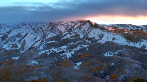 First-light-Kebler-Pass-Crested-Butte-Gunnison-Colorado-seasons-crash-aerial-drone-early-fall-aspen-tree-red-yellow-orange-forest-winter-first-snow-cold-sunrise-clouds-Rocky-Mountain-peaks-left-motion