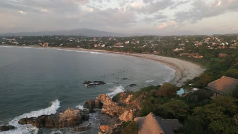 aerial-drone-la-Punta-Zicatela-tropical-sand-beach-in-Puerto-Escondido-mexico-Oaxaca-travel-holiday-destinations-filled-with-resort