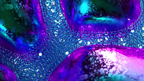 Abstract-Concept-A-Stream-of-Glowing-Blue-Neon-Particles-Flows-Around-Gray-Metal-Bubbles-Closeup-3d