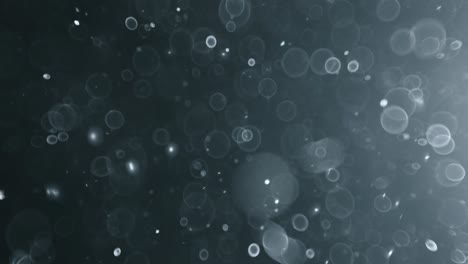 Floating-abstract-particle-bokeh-on-dark-background