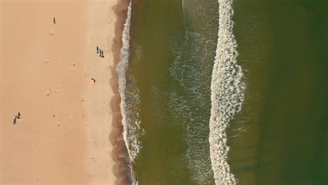 Drone-top-view-of-sea-waves-and-beach-at-sunny-day
