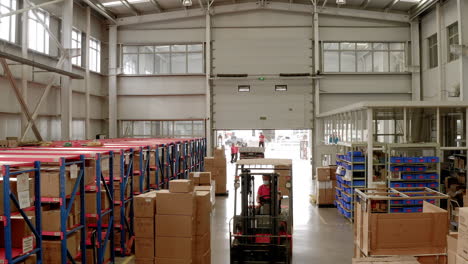 A-worker-is-driving-the-forklift-between-the-boxes-at-a-Chinese-factories-warehouse