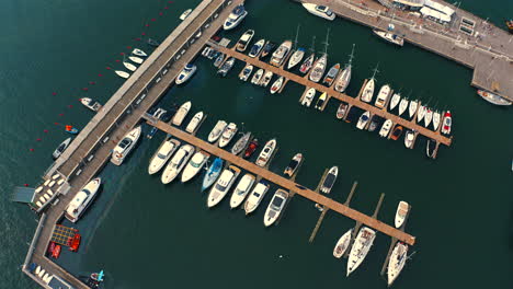 Top-aerial-view-of-marina-with-a-lot-of-luxury-yachts,-ships-and-motorboats