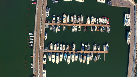 Top-view-of-the-marina-in-Sopoto-with-moored-yachts,-ships-and-motorboats-at-the-sunset