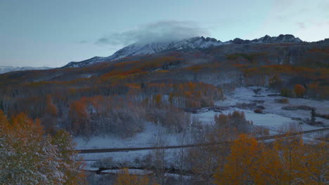 Frosted-crisp-cold-freezing-frozen-morning-shaded-Kebler-Pass-Colorado-aerial-cinematic-drone-fall-winter-season-collide-first-white-snow-red-yellow-orange-aspen-tree-forest-shaded-up-reveal
