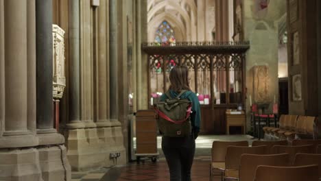 Young-woman-walking-inside-Bristol-Cathedral.-England