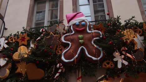 Ginger-bread-man-decorations-on-storefront-decorations-at-Festive-Christmas-market-in-Strasbourg,-France-Europe