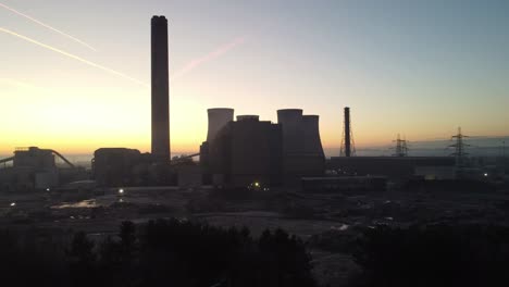Fiddlers-Ferry-power-station-aerial-rising-view-over-demolished-cooling-towers-wreckage-in-early-morning-sunrise