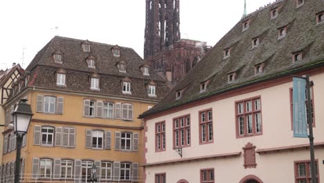 Blick-Auf-Die-Kathedrale-Von-Straßburg,-Die-über-Der-Elsässischen-Architektur-Auf-Einem-Festlichen-Weihnachtsmarkt-In-Straßburg,-Frankreich,-Europa-Thront