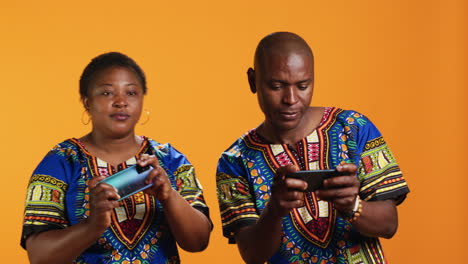 African-american-couple-playing-mobile-videogames-on-camera
