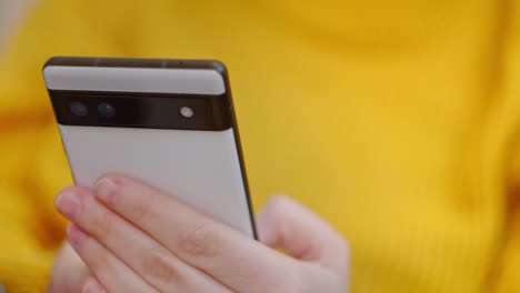Young-person-typing-smartphone,-close-up-view