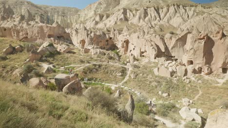 Tourists-explore-Zelve-museum-unique-rocky-landscape-Cappadocia