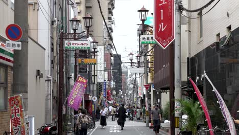 Side-Street-In-Dotonbori-Area-In-Osaka-With-People-Walking-Past