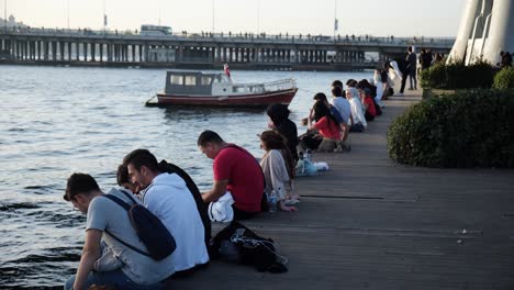 Young-Turkish-People-are-sitting-in-the-coast-of-The-Golden-Horn-Istanbul-in-a-warm-october-day