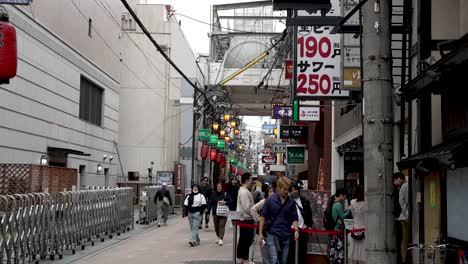 People-Queuing-On-Street-In-Dotonbori-Area-In-Osaka-Waiting-For-Restaurant-To-Open