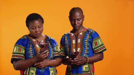 Ethnic-people-in-traditional-clothes-checking-smartphone-apps