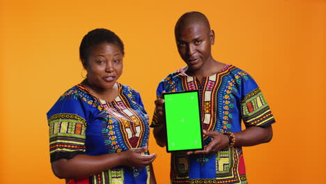 African-american-married-couple-holding-tablet-with-greenscreen