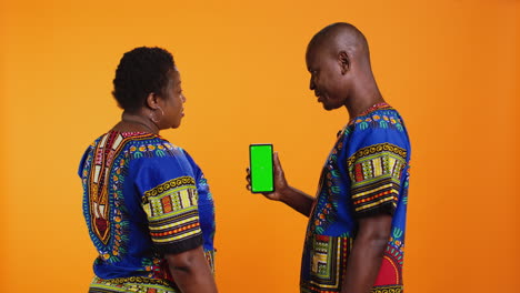 African-american-couple-looking-at-greenscreen-on-phone-layout