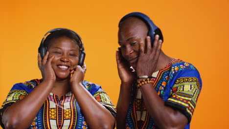 Ethnic-married-couple-listening-to-songs-on-camera