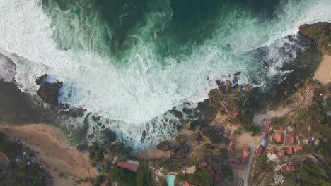 Overhead-drone-shot-of-ocean-waves-rolling-onto-tropical-shoreline