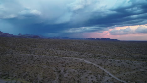 Fly-above-vast-desert-landscape-at-dusk