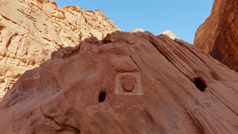 Close-up-tilt-up-of-bas-relief-in-honor-of-Lawrence-of-Arabia,-Wadi-Rum,-Jordan