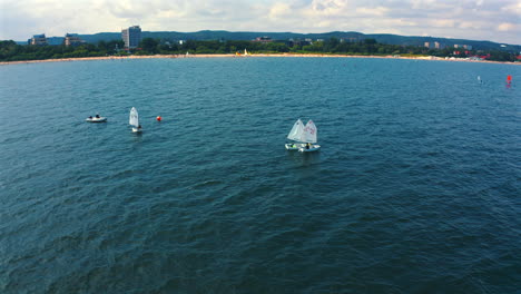 Drone-flying-above-Optimist-dinghy-boats-sailing-on-the-baltic-sea-at-sunny-day-in-Sopot