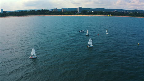 Aerial-view-of-Optimist-dinghy-boats-sailing-on-the-baltic-Sea-at-sunny-vacation-day