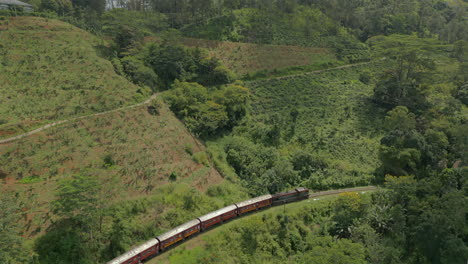 Aerial-Drone-Shot-of-Diesel-Passenger-Train-in-Highlands-Hill-Country-in-Sri-Lanka