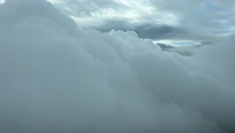 Cloud-scene-shot-from-an-airplane-cabin,-as-seen-by-the-pilots-in-a-real-time-flight-at-5000m-high,-with-a-clouded-winter-day