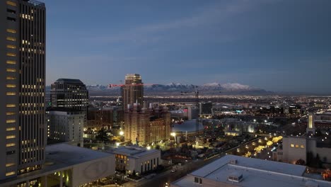 Downtown-Salt-Lake-City,-Utah-at-nighttime-with-construction-at-Temple-Square---aerial