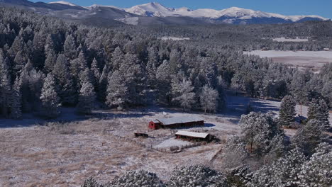 Red-Barn-open-space-christmas-first-snow-Evergreen-Front-Range-Denver-Mount-Blue-Sky-Evans-aerial-cinematic-drone-crisp-freezing-cold-morning-beautiful-blue-sky-forward-pan-up-reveal-motion