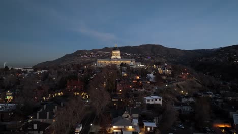 Salt-Lake-City-at-twilight-with-the-Utah-State-Capitol-building-glowing---aerial-push-in