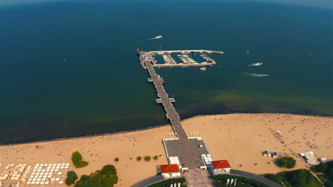 Top-view-of-Monciak-pier-in-Sopot,-Poland-at-sunny-vacation-day-with-baltic-sea-in-the-background