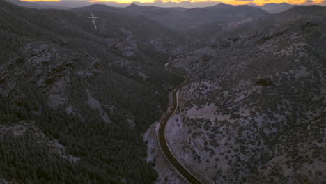 Colorado-Christmas-first-snow-frosted-Mount-Lindo-memorial-golden-sunset-Christian-Catholic-Jesus-Cross-hope-and-faith-285-highway-Morrison-Conifer-Evergreen-aerial-cinematic-drone-pan-up-forward