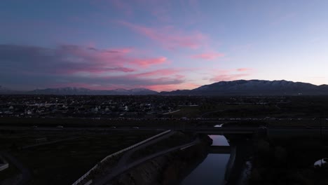 Lehi,-Utah-sunset-with-the-colorful-sky-reflecting-off-the-Jordan-River---pullback-aerial
