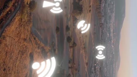 vertical-aerial-landscape-approaching-big-city-at-distance-with-wifi-antenna-animation-logo