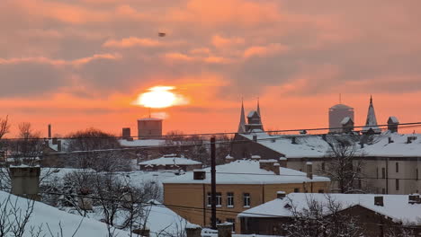 Golden-winter-sunset-over-a-snowy-village---time-lapse