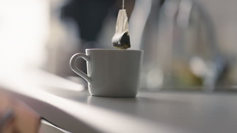 Steeping-tea-bag-in-a-warm-mug-on-a-kitchen-counter