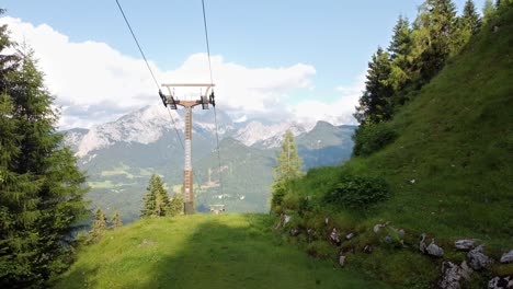 Drone-Flight-Over-Forest-With-Cable-Cars-And-Alps-In-Background