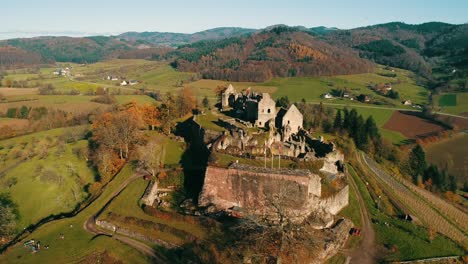 Old-historic-castle-ruins-on-a-hill-in-the-middle-of-an-autumnal-landscape