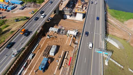 Heavy-A1-highway-traffic-while-constructing-bridge-in-between,-aerial-view