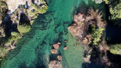 Crystal-clear-river-water-in-Argentina,-aerial-top-down-view