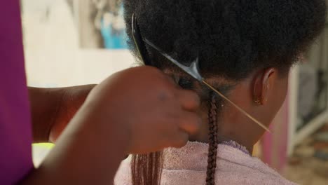 Hair-salon-staff-member-commences-fitting-of-extensions-to-female-head